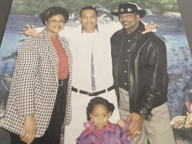 Jessie James Askew Jr. (center) smiles with his mother, father and daughter in 2020, while Askew was incarcerated at Telfair State Prison in McRae-Helena, Ga.